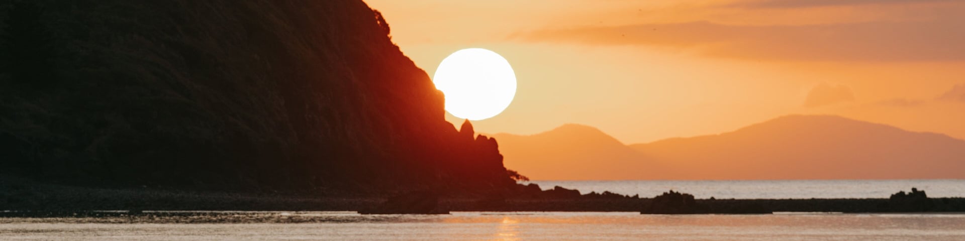 Cape Hillsborough National Park featuring a sunset and general coastal views as well as a couple