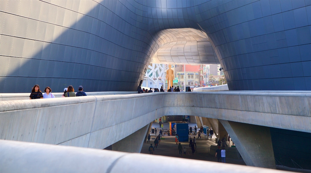 Dongdaemun Design Plaza caratteristiche di vista interna e architettura moderna cosi come un piccolo gruppo di persone
