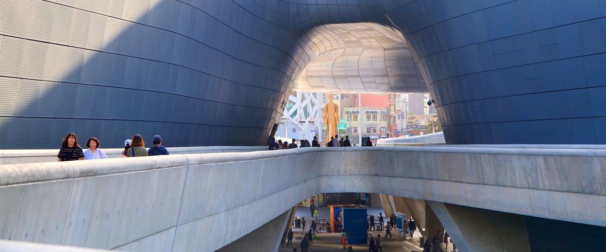 Dongdaemun Design Plaza featuring interior views and modern architecture as well as a small group of people