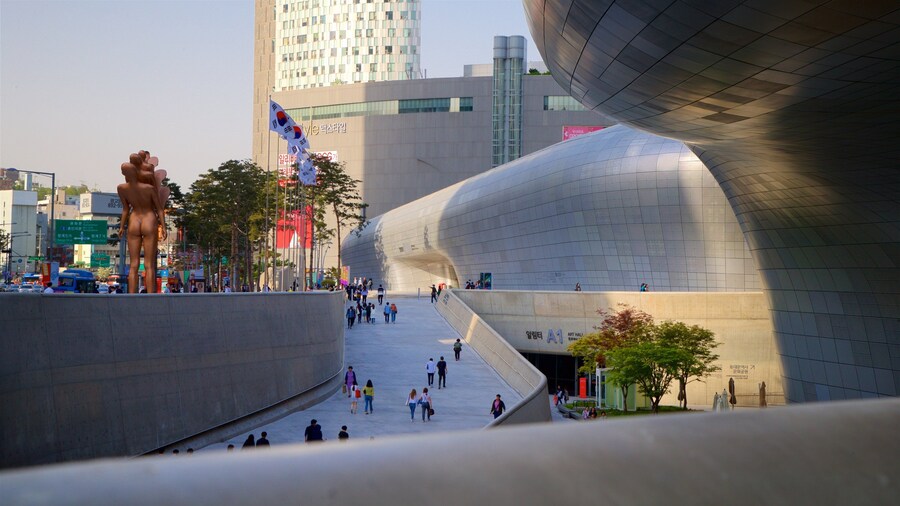 Dongdaemun Design Plaza showing outdoor art, a city and a sunset