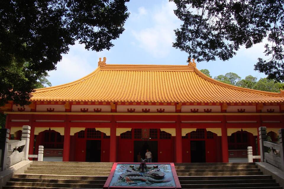 A traditional building with a curved roof and red walls.