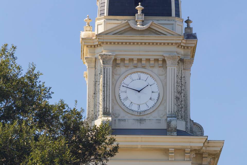 A clock tower with a dome and columns.