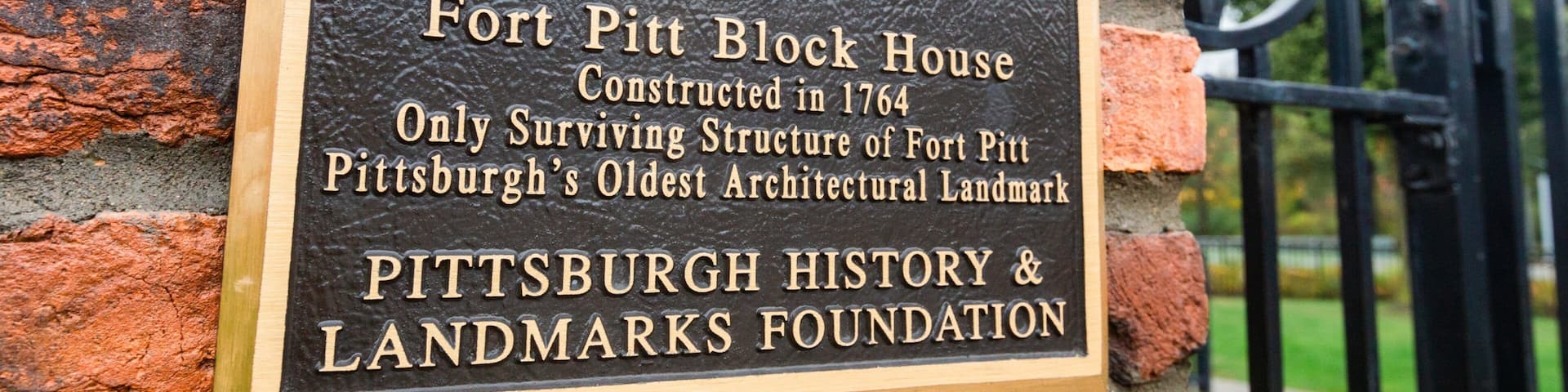 A historic landmark plaque on a brick wall.