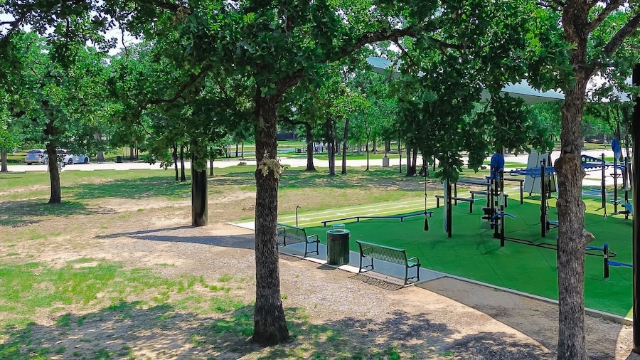 Panorama aerial view outdoor fitness equipment on artificial grass turf, shade sail cover, public community recreation center in Flower Mound, Texas, single double stations, complete gyms courses