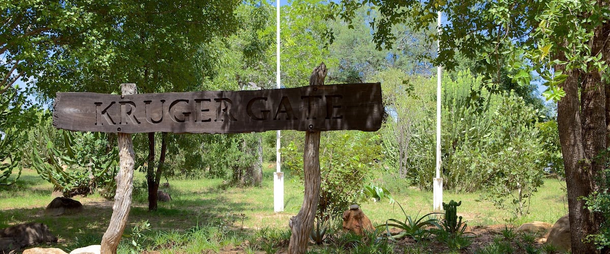 Paul Kruger Gate showing signage and a garden