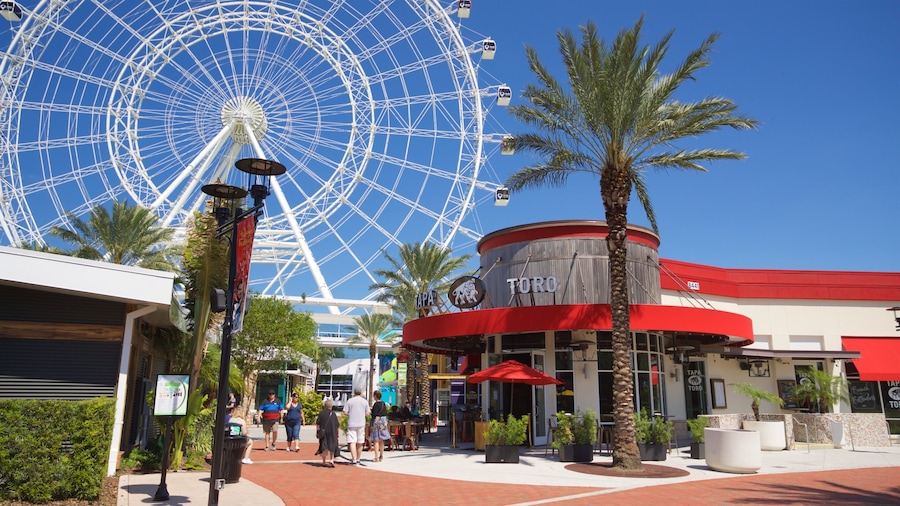 The Wheel at ICON Park surrounded by shops and palm trees in Orlando, Florida.