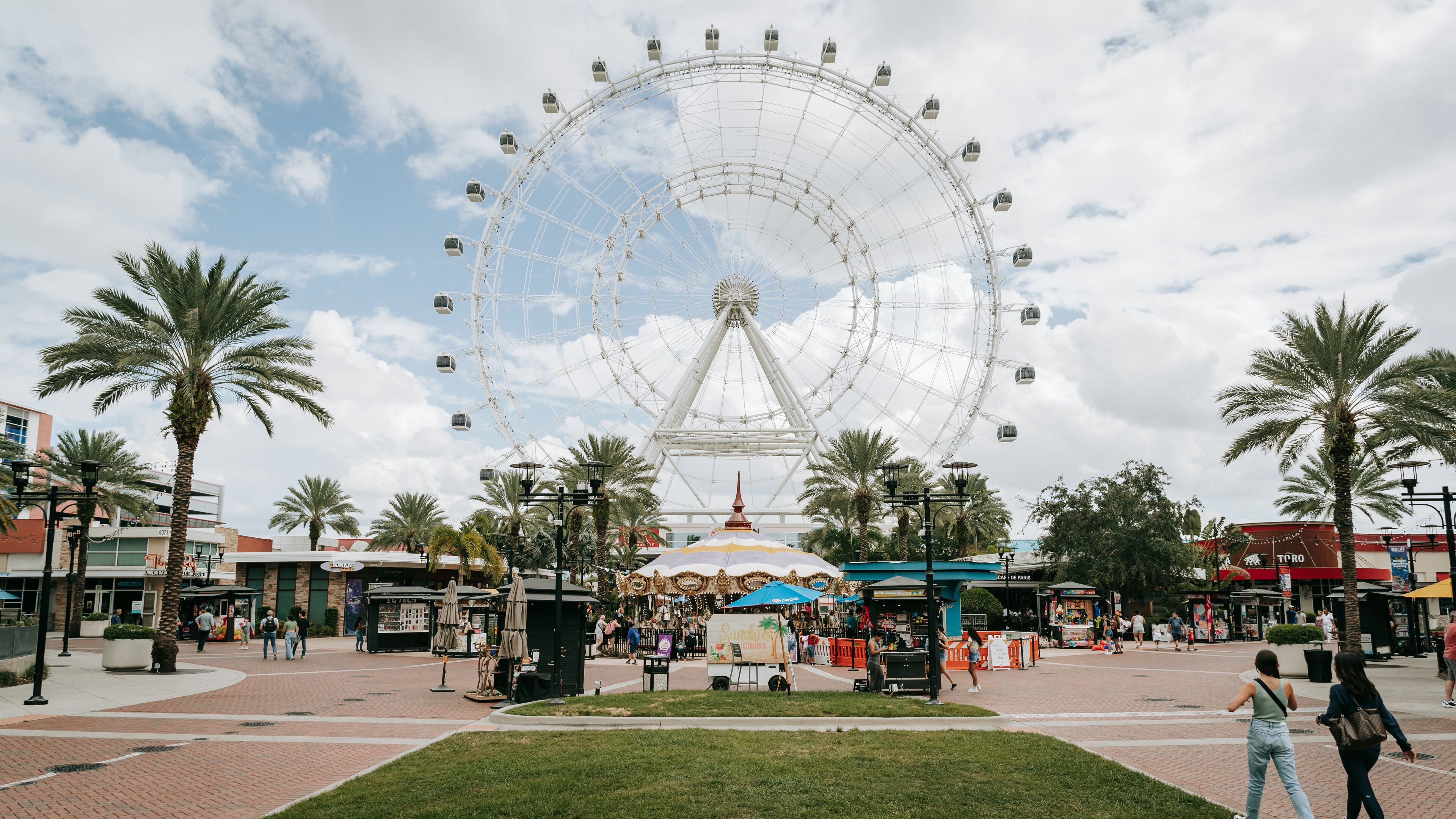 The Wheel at ICON Park™ showing rides and a square or plaza
