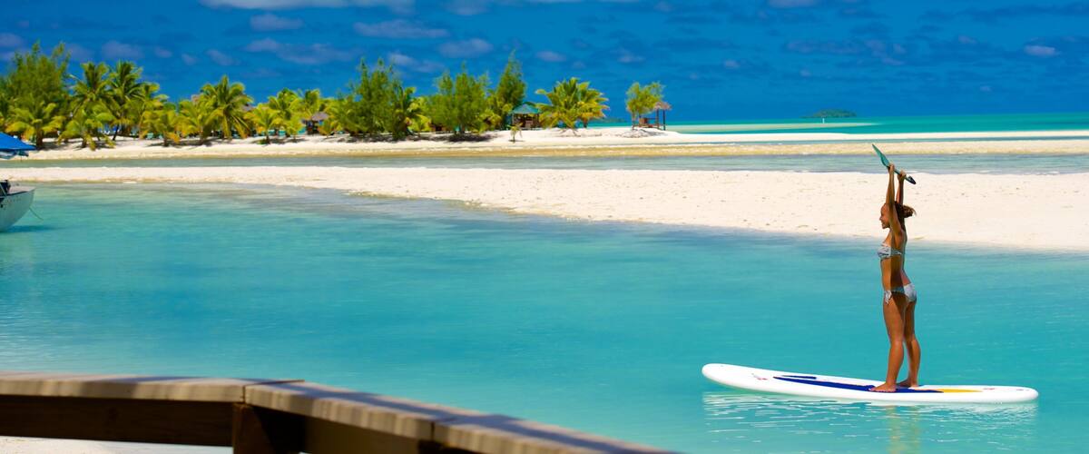 Aitutaki showing watersports and a sandy beach as well as an individual femail