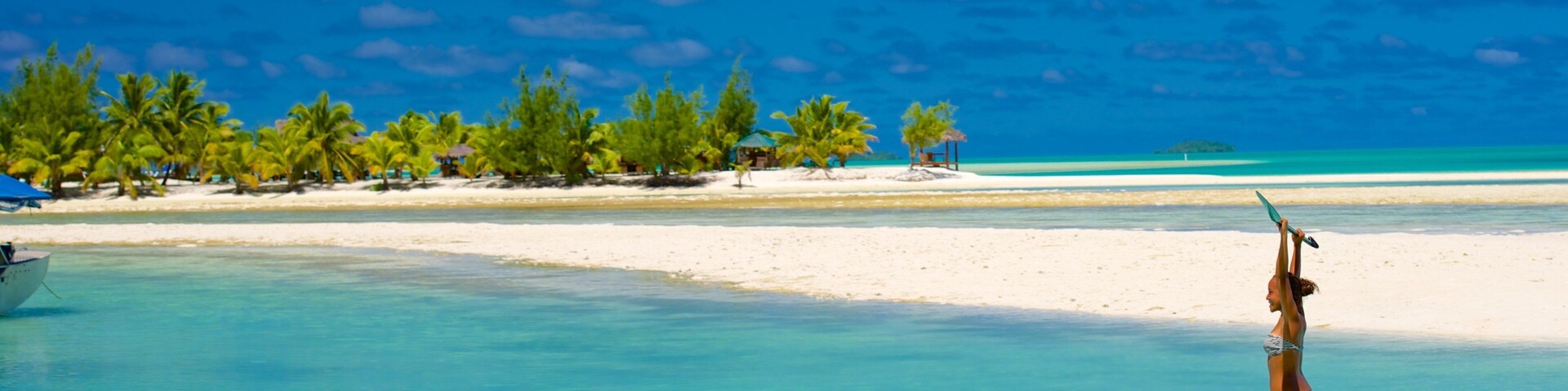 Aitutaki showing a sandy beach and watersports as well as an individual femail