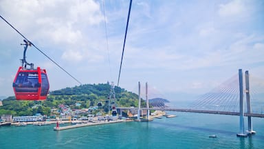 A cable car system, a bridge, and a coastal town.