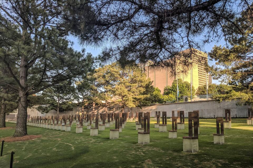A cemetery with headstones and trees.