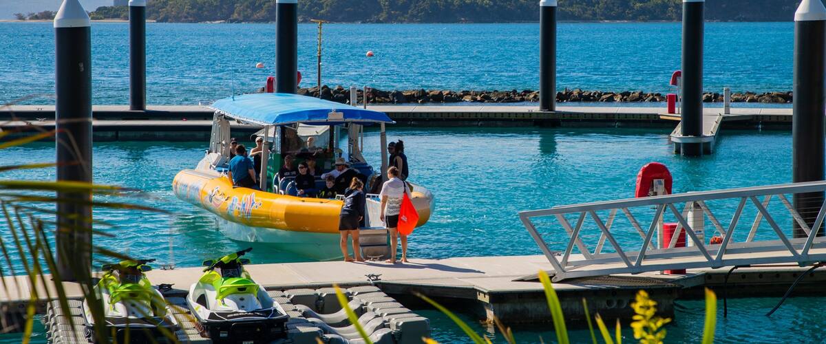 Daydream Port featuring a bay or harbor and boating as well as a small group of people