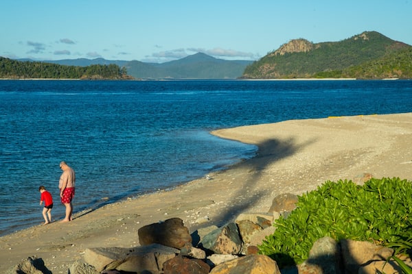Daydream Beach featuring general coastal views as well as a family