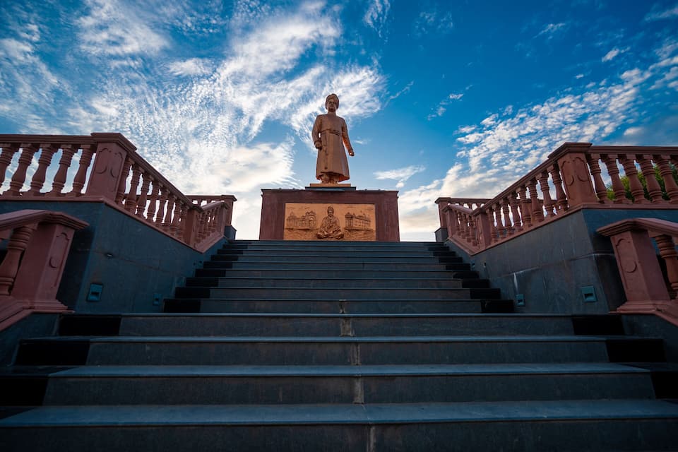 Una estatua en una escalera con barandillas a ambos lados.