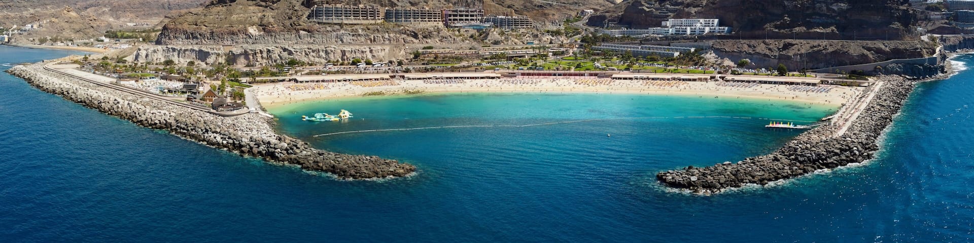 Aerial drone photo. Playa de Amadores, large cove with a white sand beach. Puerto Rico de Gran Canaria, Canary Islands, Spain.