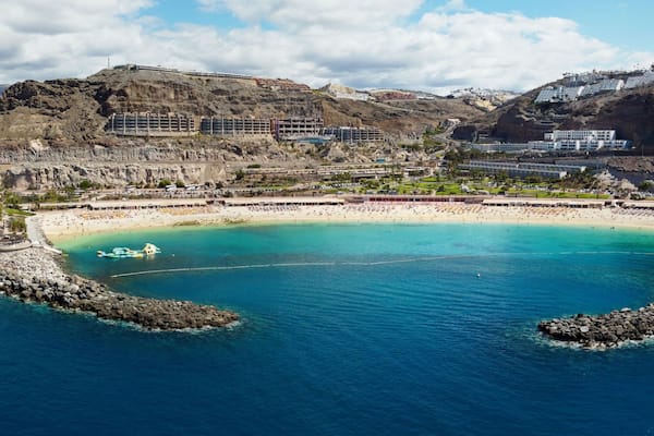 Aerial drone photo. Playa de Amadores, large cove with a white sand beach. Puerto Rico de Gran Canaria, Canary Islands, Spain.