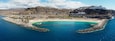 Aerial drone photo. Playa de Amadores, large cove with a white sand beach. Puerto Rico de Gran Canaria, Canary Islands, Spain.