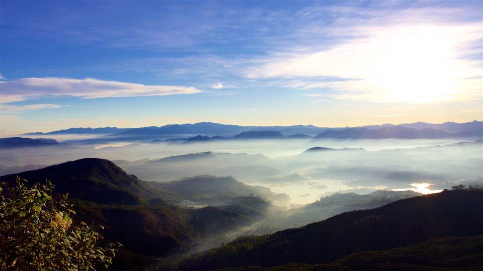 A mountainous landscape with a valley and a lake.