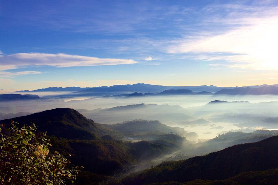 A mountainous landscape with a valley and a lake.