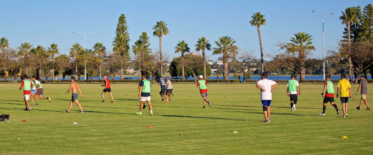 Langley Park showing a sporting event and a garden as well as a small group of people