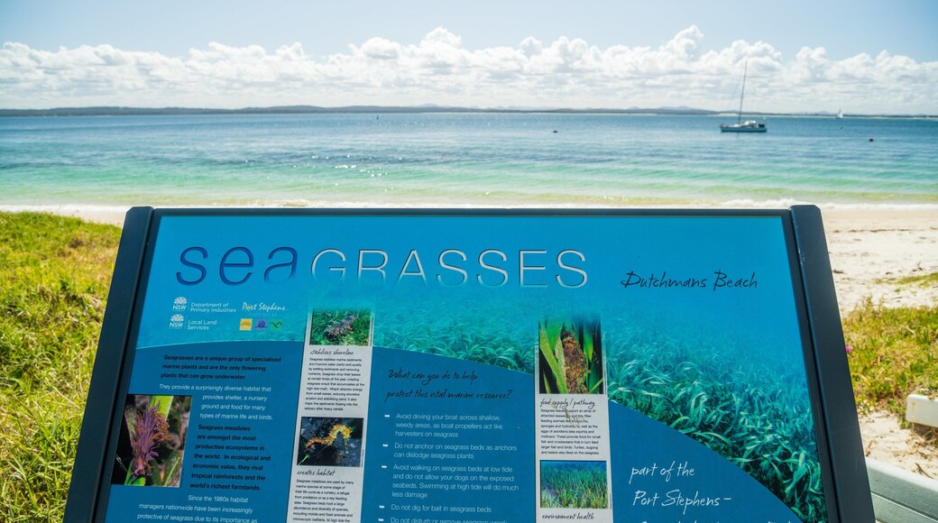 Dutchmans Beach featuring signage, a sandy beach and general coastal views