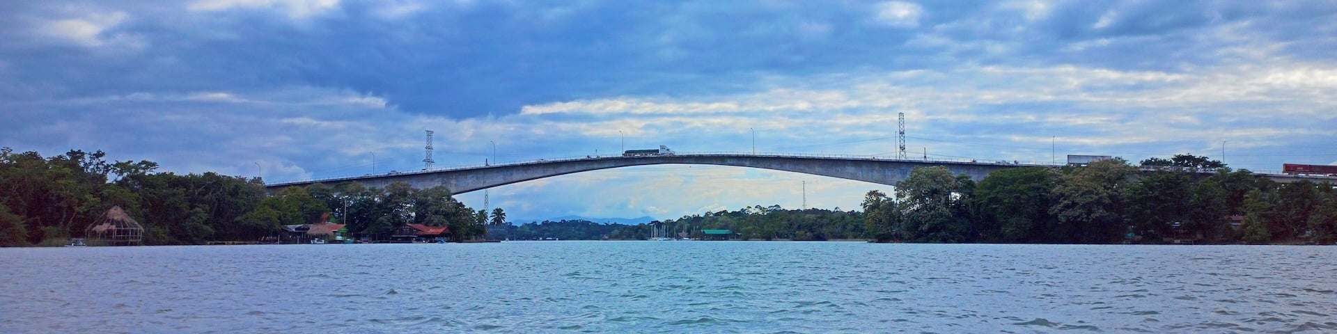 View of the Rio Dulce Bridge from the water at sunset in Izabal, Guatemala. Vacation concept