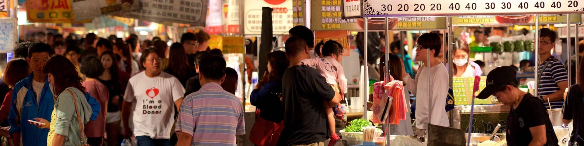 Tainan showing night scenes and markets as well as a large group of people