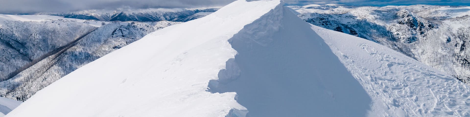 A snow-covered mountain peak with a clear sky.