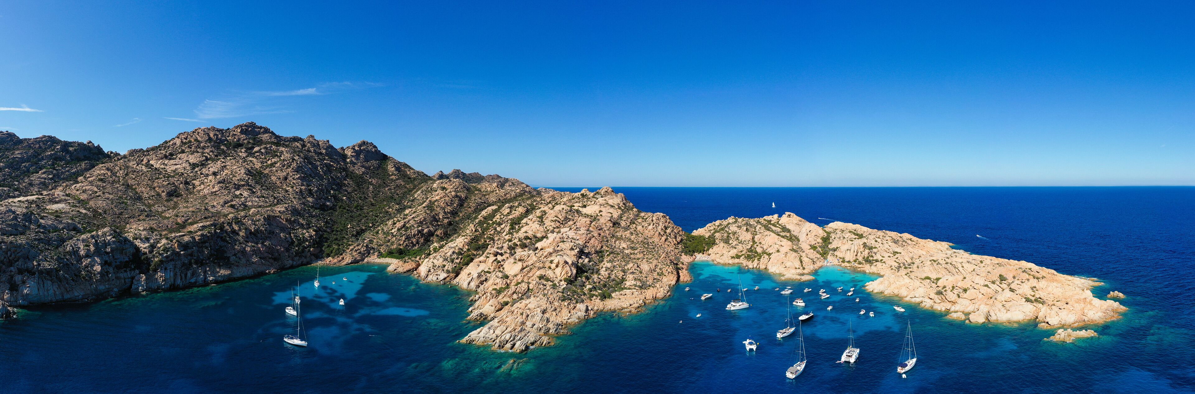 Stunning panoramic view of Cala Coticcio also known as Tahiti with its rocky coasts and small beaches bathed by a turquoise cllear water. La Maddalena Archipelago, Sardinia, Italy.