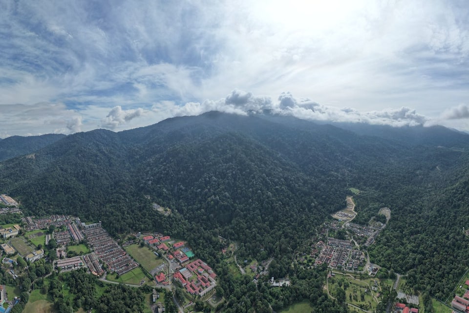 A mountainous landscape with a town in the valley.