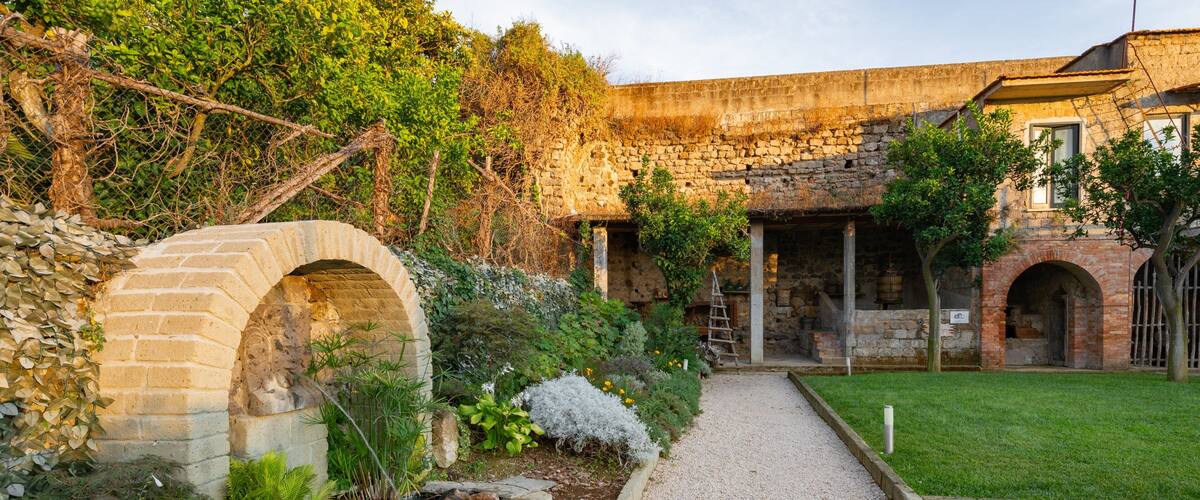Sorrento Foundation featuring a pond, a garden and a sunset