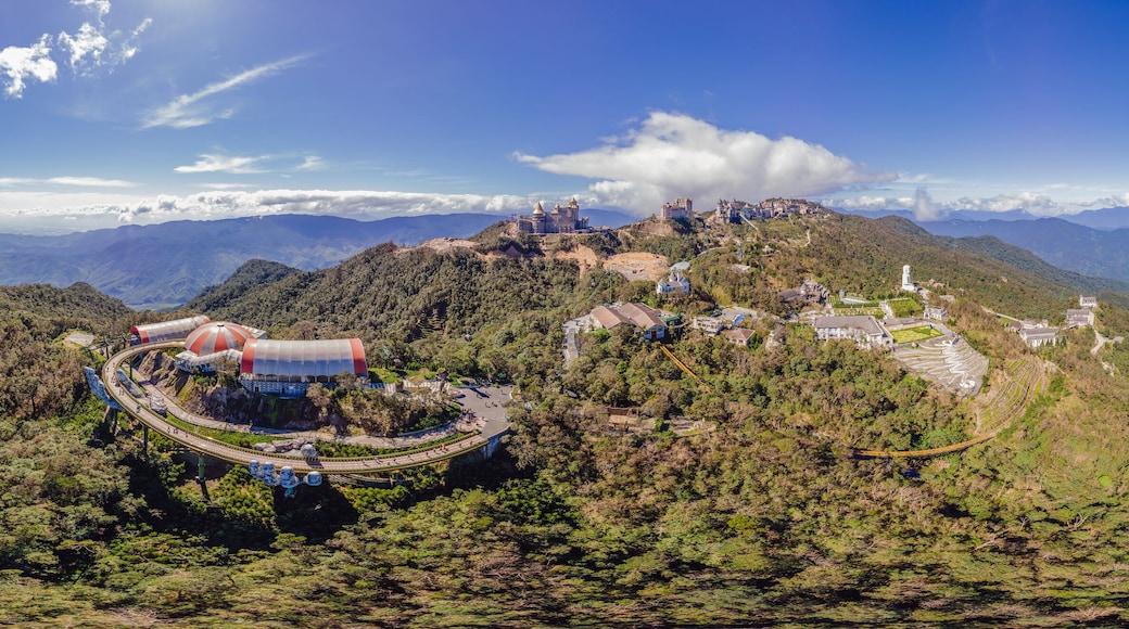Top aerial view of the famous Golden Bridge is lifted by two giant hands in the tourist resort on Ba Na Hill in Da Nang, Vietnam