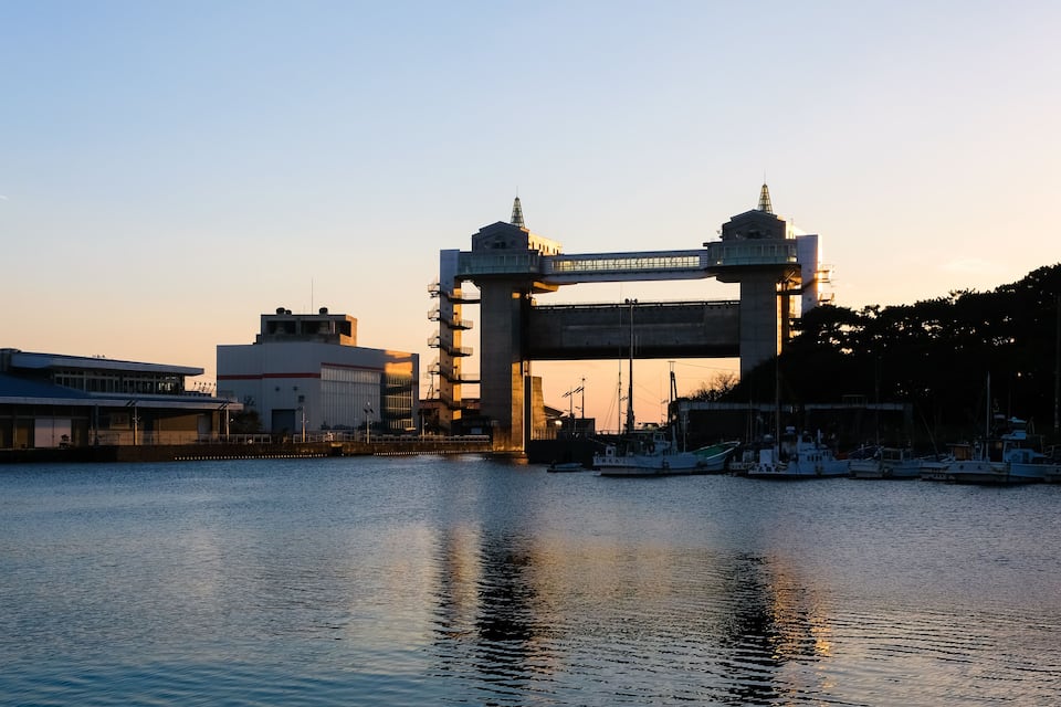 A bridge over water with boats docked nearby.