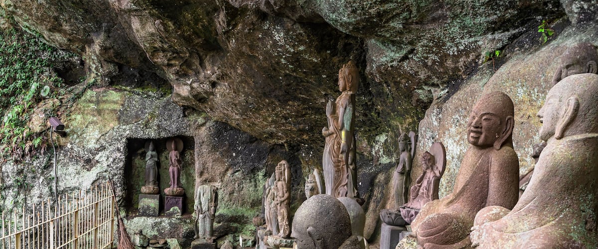 Buddhist statues of Saigoku Kannon bodhisattva surrounded by sculpture of other divinities and monks created in 18th century by Jingoro Eirei Ono in the Mount Nokogiri.