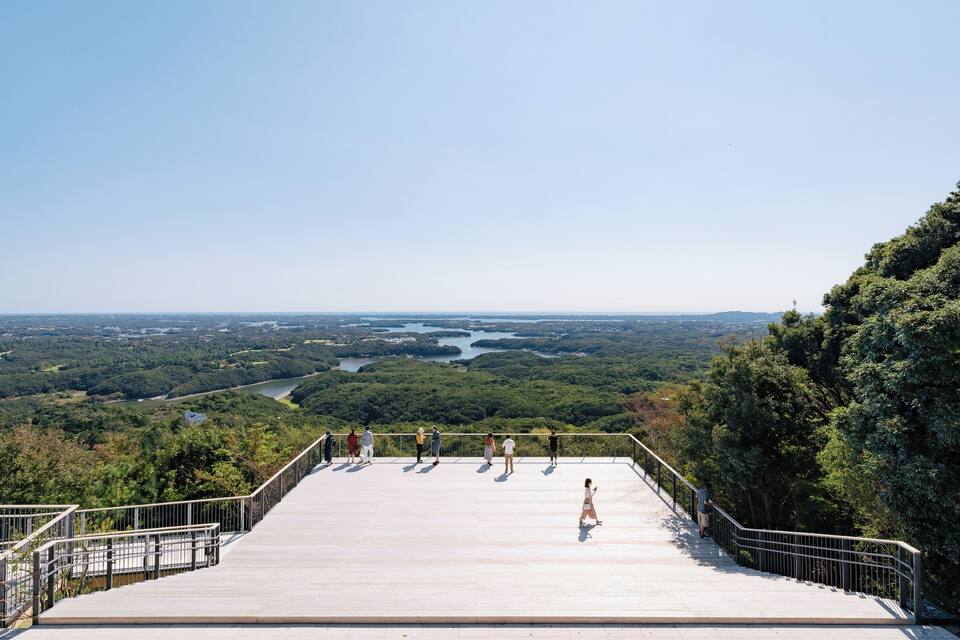 A viewing platform overlooking a river and forested landscape.