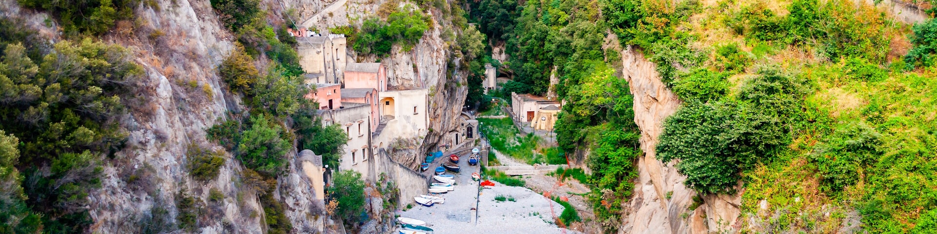 Amazing small beach in high rocky mountains gorge. Several village houses built on the rocks. Tyrrhenian sea bay in Campania region called Fiordo di Furore