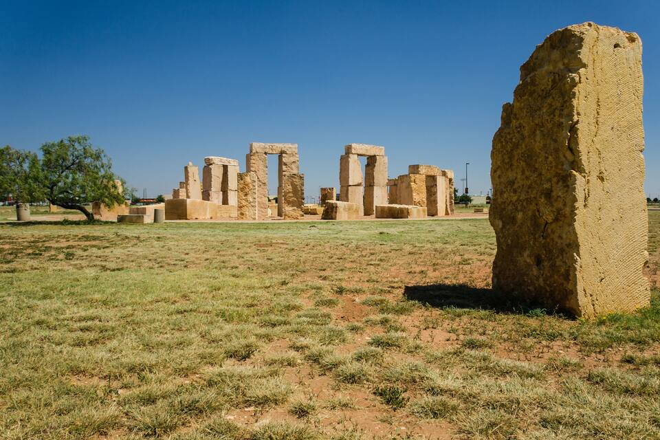 Ancient stone ruins with a prominent standing stone in the foreground.