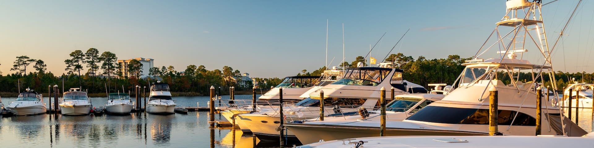 A marina with several yachts docked at the pier.