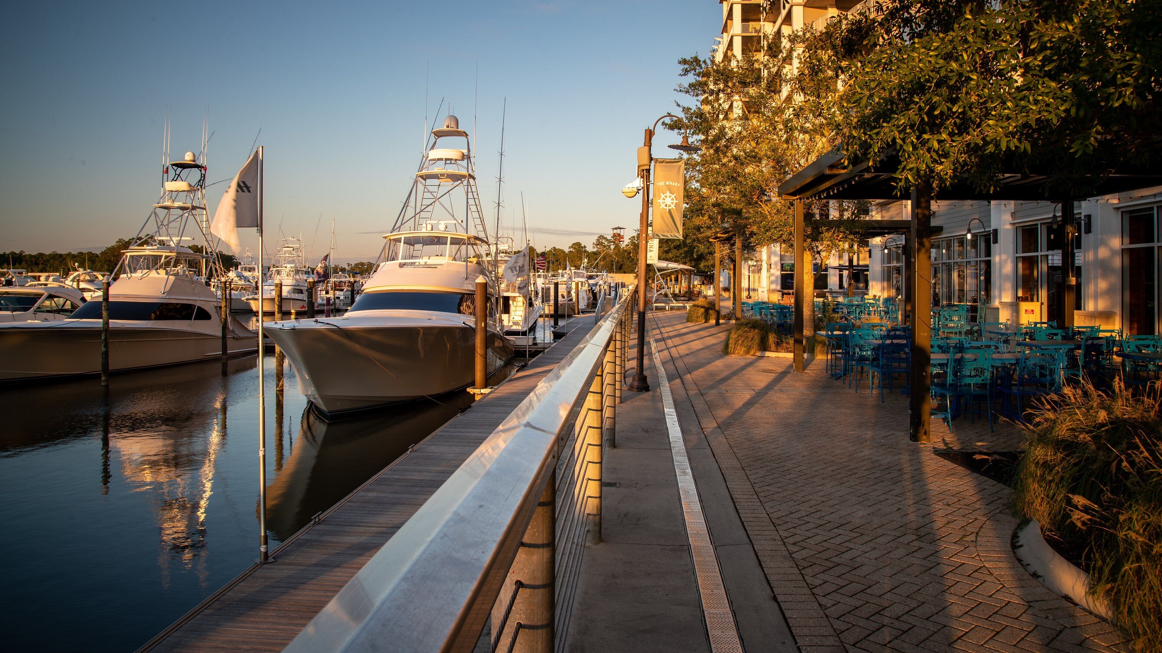 The Wharf which includes a bay or harbor and a sunset