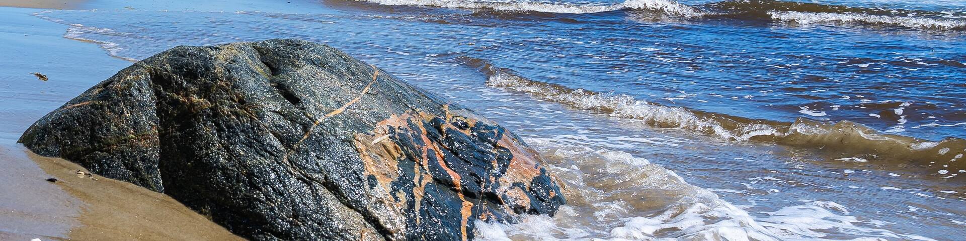 Huge boulders in the sand on the northern end of the beach on Plum Island off the northeastern coast of Massachusetts, north of Cape Ann, in the United States. National Wildlife Refuge