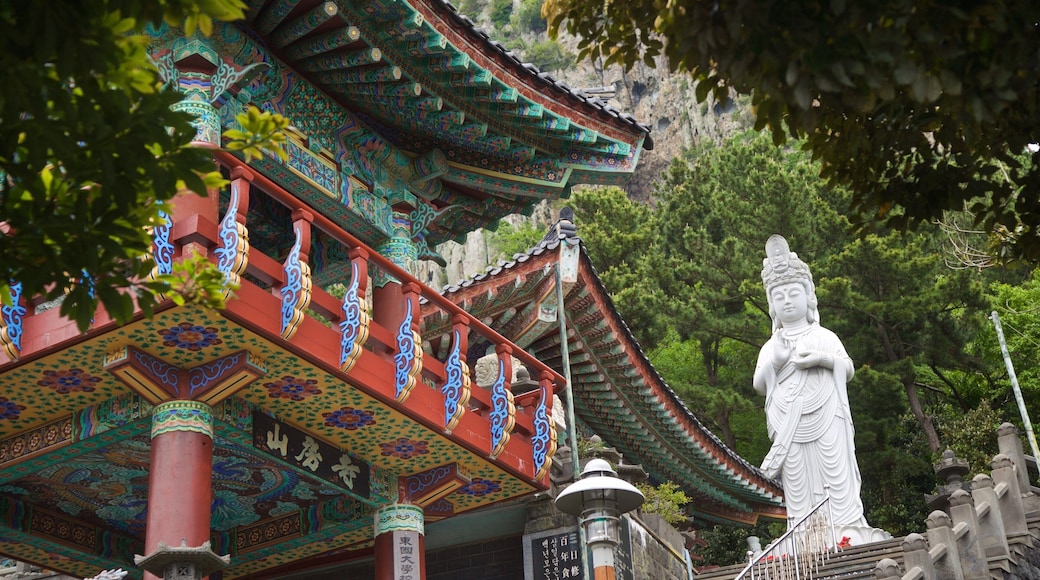 Sanbangsan Mountain showing a statue or sculpture and heritage elements as well as a small group of people