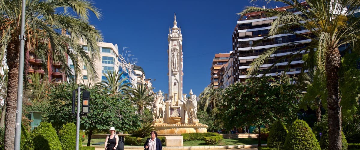 Placa de los Luceros showing a garden, a fountain and street scenes