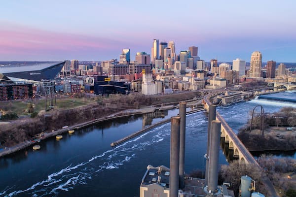 A city skyline with a river, bridges, and industrial structures.