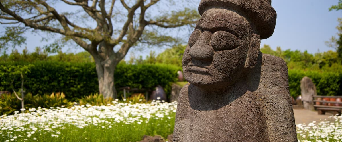 Jeju Folk Village Museum which includes a statue or sculpture, wildflowers and heritage elements