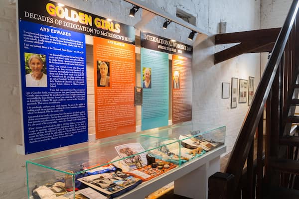 A museum exhibit with informational posters and a glass display case.