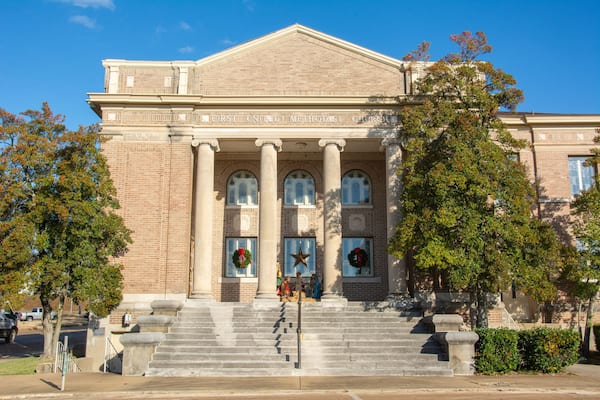 Greek-style temple front view of the Classical Revival style historic First United Methodist Church and community center on Izard Street in Forrest City, Arkansas, USA