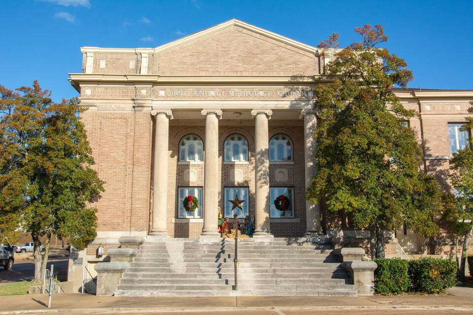 A historic building with a classical facade, large columns, and a prominent entrance.