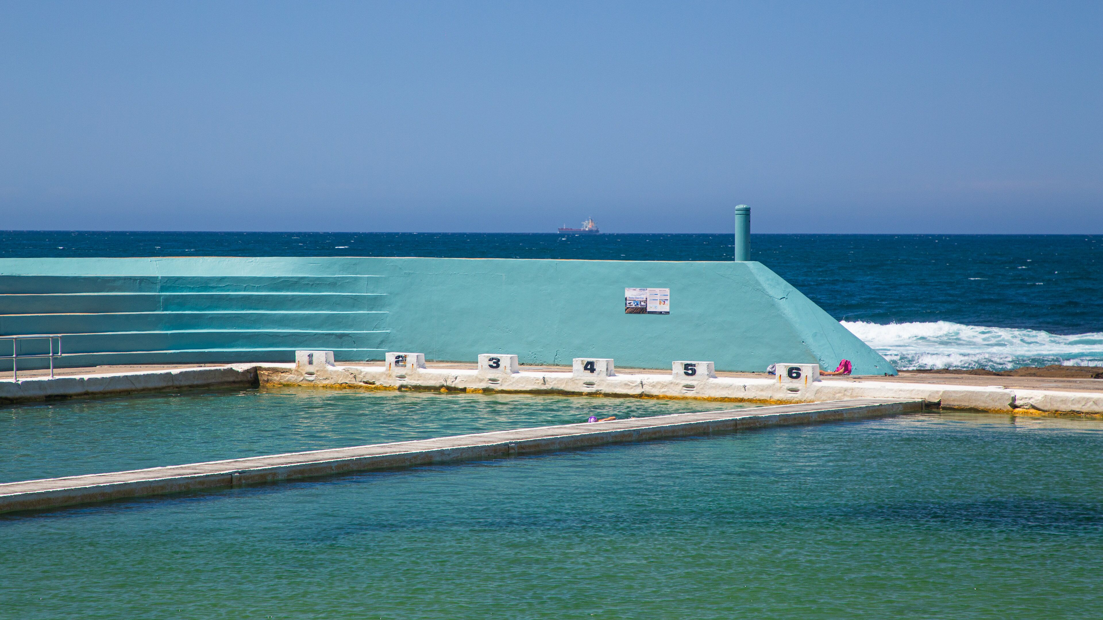 Newcastle Ocean Baths which includes a pool and general coastal views