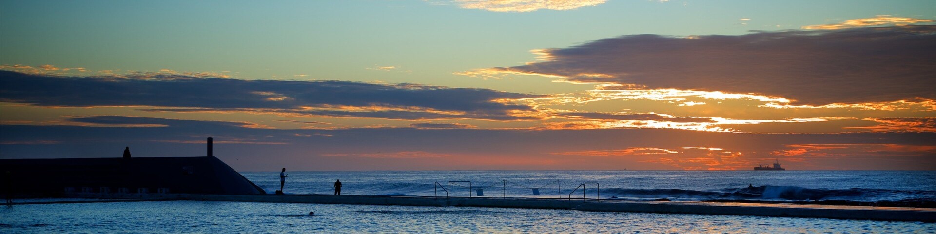 Newcastle featuring a sunset and a pool