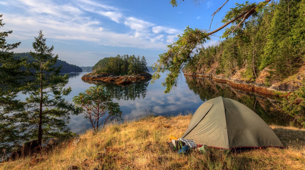 Kayakers camp on Penn Island in Sutil Channel between Read and Cortes Islands British Columbia Canada.